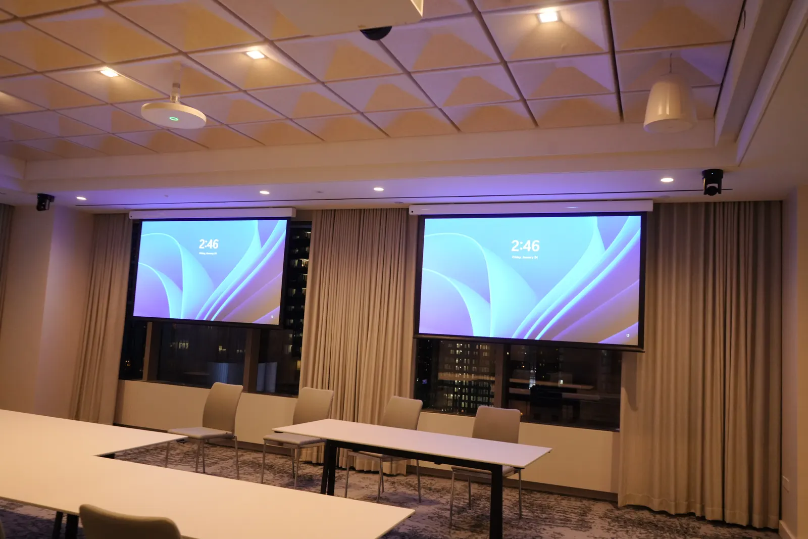 Training room with two projection screens and an acoustic ceiling
